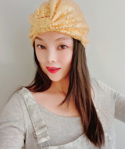 Champagne gold sequined headscarf with a draped knot at the front.