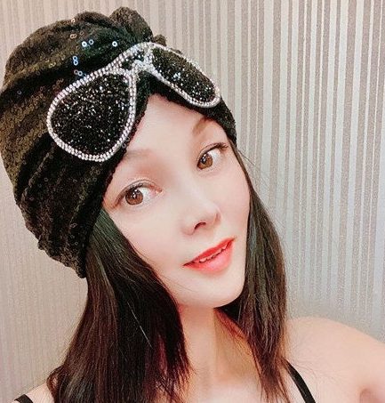 Black sequined headscarf adorned with rhinestone sunglasses pattern